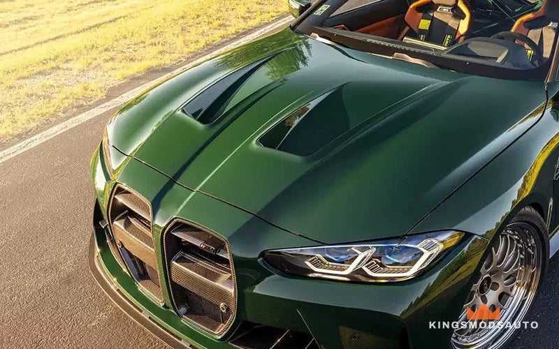 The same vented hood painted in body color on a green BMW G8X M3/M4